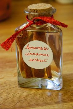 cinnamon sticks in a small glass bottle with a red ribbon around the top that says homemade cinnamon exact