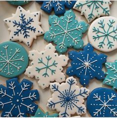 snowflake cookies are arranged on a plate