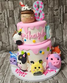 a three tiered cake decorated with animals and letters