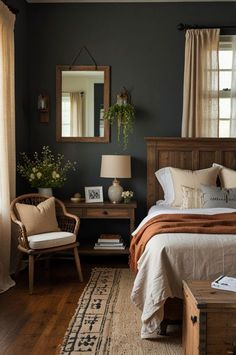 a bed room with a neatly made bed next to a chair and table in front of a window