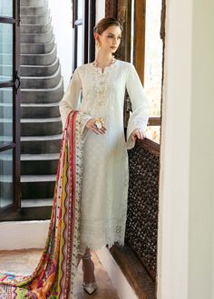 Brand: Kanwal MalikCollection: Mayal by Kanwal Malik Unstitched Luxury Lawn CollectionFabric: Lawn DESCRIPTION: Drenched in the ethereal hues of anglic white canvas get ready to be enchanted by the delicate embroidery that weaves an intricate delicate motif adorned with graceful florals and dainty patterns. Luxurious schiffli border elevate this masterpiece, turning it into a breathtaking manifestation of heritage and elegance. As your eyes wander, a luscious, pure silk dupatta unfolds, showcasing an artistry of blooming flowers, playful festoons, and vivid hues. Encased within a geometric border, it exudes a vibrant festivity that enlivens the entire composition. DESIGN DETAILS: Embroidered Shirt Front Center Panel (Lawn) – 1Pcs Embroidered Front Right Panel (Lawn) – 1Pcs Embroidered Fron Lengha Modern, Pakistani Dresses Online Shopping, Latest Kurtis, Chiffon Suit, Organza Suits, Pakistani Dresses Online, Latest Kurti, Pakistani Fashion Casual, Indian Salwar Kameez