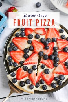 an image of a fruit pizza with blueberries and strawberries on top in a pan