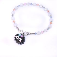 a beaded bracelet with a black sheep charm