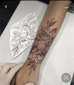 a woman's arm with flowers on it