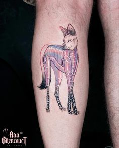 a tattoo on the leg of a man with a pink and black fox design on it