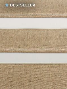 carpeted stairs with white handrails and beige carpeting on the bottom step