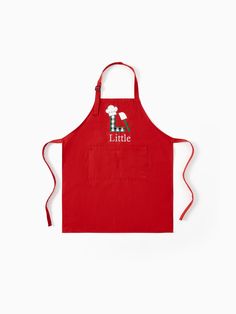 a red apron that says little with sheep on the front and back, in white lettering