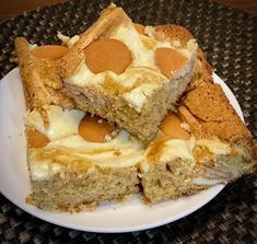 four pieces of cake sitting on top of a white plate