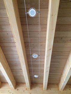 the ceiling is made of wood and has several lights hanging from it's sides