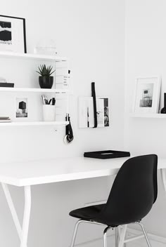 two black chairs sitting at a white desk