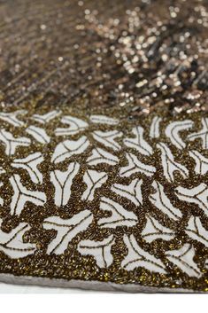 an intricately designed area rug with gold and silver glitters