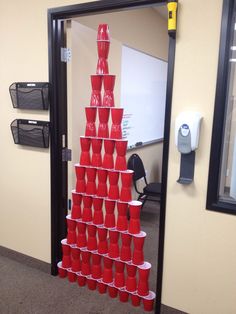 a stack of red cups in an office cubicle