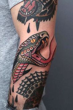 a man with a snake tattoo on his arm