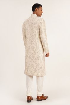 Silver cream sherwani with front buttons and floral embroidery. Paired with churidar.
Component: 2
Pattern: Embroidered
Type Of Work: Floral
Neckline: Mandarin
Sleeve Type: Full
Fabric: Silk
Color: Silver,Cream
Other Details: 
Front buttons
Occasion: Wedding - Aza Fashions Raw Silk Sherwani With Naqshi For Reception, Sherwani With Zari Work For Reception, Sherwani With Resham Embroidery For Reception, Straight Kurta, Reception Sherwani With Resham Embroidery And Straight Kurta, Sherwani For Reception With Resham Embroidery And Straight Kurta, Sherwani With Resham Embroidery For Reception, Naqshi Bandhgala In Jamawar For Reception, Reception Sherwani With Dabka Work, Festive Sherwani With Naqshi For Reception