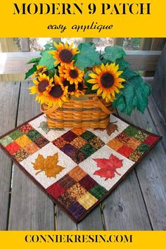 a basket with sunflowers and leaves on a table