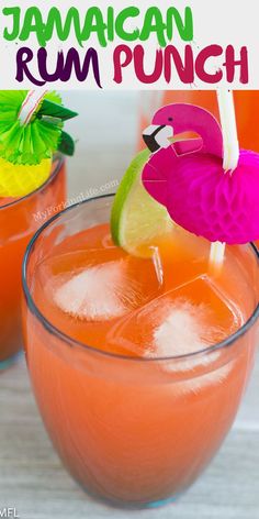 two glasses filled with orange juice and garnished with a pink flamingo flower