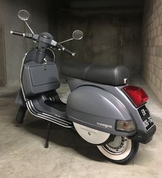 a motor scooter parked in a garage with no one on the back seat