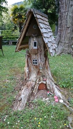 a tree stump with a house built into it