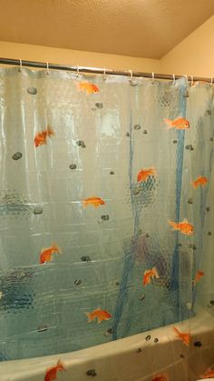 a shower curtain with fish on it in a bathroom