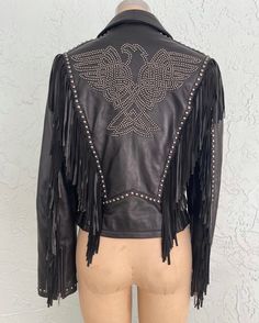 "Vintage 80s 90s Black Leather Jacket with the most amazing Studded Eagle & Fringe Design This Jacket is just so BAD ONE ONLY DON'T MISS OUT LOVE ROCKS VINTAGE ITEM DETAILS & DESCRIPTION . Classic Motorcycle Jacket . Silver Studded EAGLE . Super soft leather . Long Fringe . Front Zipper . Front Pockets . Attached Waist Buckles at Back . Lined - Black Label: Paris Paris Size: S - refer to Measurements - NO RETURNS FOR NOT FITTING! Era: est. 1980s 1990s Color: Black with Silver Studs - refer to Ph Fitted Leather Rock Jacket For Parties, Fitted Rock Leather Jacket For Party, Fitted Rock Style Leather Jacket For Party, Black Rock Style Leather Jacket For Party, Fitted Rock Style Leather Jacket For Concerts, Rock And Roll Black Winter Outerwear, Black Rock And Roll Winter Outerwear, Fitted Rocker Leather Jacket For Festivals, Black Leather Jacket With Long Sleeves For Festivals