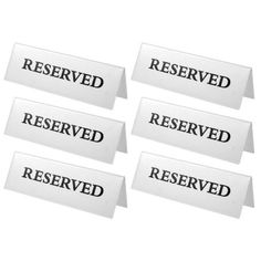 six white reserved labels with black lettering on them