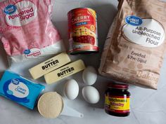 ingredients to make an ice cream sandwich laid out on a counter top, including eggs, butter, and flour