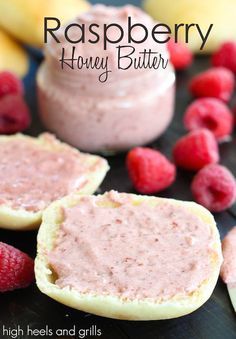 raspberry honey butter is spread on top of bread with raspberries around it