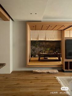 a living room filled with furniture and a flat screen tv sitting on top of a wooden floor