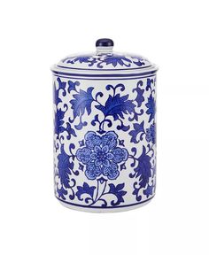 a blue and white jar with flowers on it's lid is shown in this image