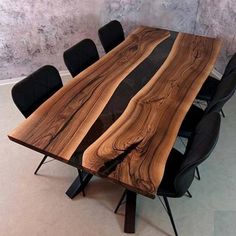 a wooden table with black chairs around it