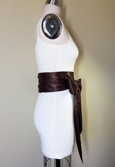 "Chocolate Brown Sash Chocolate Satin Sash Reversible Waist Wrap Belt Obi Sash Bow Belt Bridesmaid Sash, Wedding Bridal Sash Satin Swank Make this Satin Swank® reversible waist sash the perfect finishing touch for your wedding, bridesmaid, or special occasion dress, or just the right piece to add instant polish to your dress or top. This extra long version is 3.5 inches wide, 120 inches long, and will wrap around most waist sizes two times with a generous length remaining to tie in a bow or a si Fitted Sashes With Satin Bow, Elegant Fitted Tie-waist Sash, Elegant Fitted Tie Waist Sash, Formal Sashes With Matching Belt, Fitted Bridesmaid Sash, Formal Fitted Sash With Tie Back, Formal Fitted Sash With Tie Waist, Bridesmaid Sash, Waist Sash