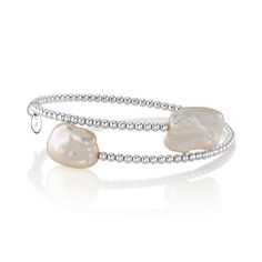 This chic bangle pearl bracelet features two 9mm white baroque freshwater pearls on each side. The pearls are mounted on the finest 18K gold bangle bracelet, in your choice of white gold or yellow gold. The bangle comes in a standard one size fits all. This item comes packaged in a beautiful jewelry gift box, perfect for gifting. Luxury Statement Pearl Bangle Bracelet, Pearl White Bangle Pearl Bracelet, Pearl White Pearl Bangle Bracelet, Luxury White Baroque Pearl Bracelets, Pearl White Bangle Bracelet With Pearl Charm, Pearl White Bangle With Pearl Charm, Stackable White Pearl Bracelet, White Stackable Pearl Bracelet, White Pearl Stackable Bracelets