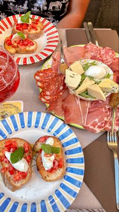 several plates with food on them sitting on a table