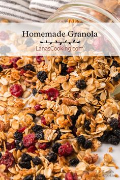 homemade granola in a glass jar with berries and blueberries on the side, text overlay reads homemade granola