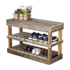 a wooden shelf with shoes and plants on top