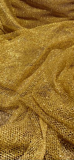 an image of a gold cloth textured with metallic threads and sequins