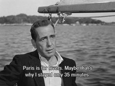 a man sitting on top of a boat next to the ocean with a caption in front of him that reads paris is for lovers maybe maybe that's why i stay only 35 minutes