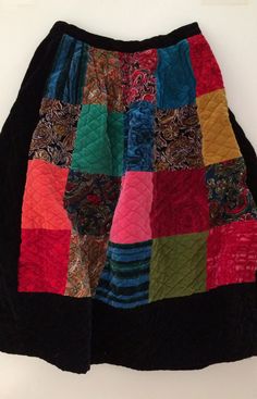 a multicolored patchwork skirt hanging on a wall