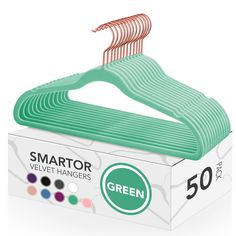 a green hanger in a box on a white background with the words smart velvet hangers 50 per pack