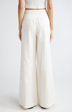 Dramatically flared wide legs lend runway-worthy movement to ultrahigh-waist pants softly kissed with fresh linen and cotton fibers. 32 1/2" inseam; 32" leg opening; 12" front rise; 15 1/2" back rise (size 8) Zip fly with hook-and-bar closure Front slant pockets 44% linen, 29% cotton, 27% lyocell Dry clean Made in the USA White Chic Wide Leg Flares, Chic White Wide Leg Flares, Chic White Wide-leg Flares, Chic Straight Leg Flares For Spring, Chic Cotton Flares For Summer, Chic Cotton Summer Flares, Beige Cotton Wide Leg Full-length Pants, Beige Cotton Wide Leg Full Length Pants, Beige Cotton Full Length Wide Leg Pants