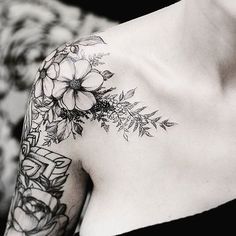 a woman's shoulder with flowers on it