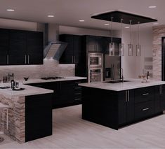 a large kitchen with black cabinets and white counter tops