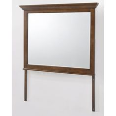 a wooden frame mirror hanging on the wall