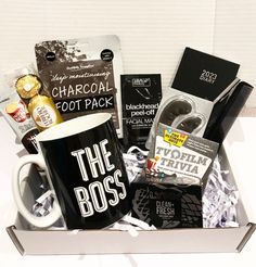 a gift box containing a coffee mug, chocolates, and other items for the boss