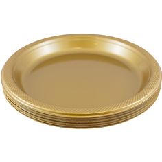 gold plates stacked on top of each other in the shape of an oval plate with wavy edges