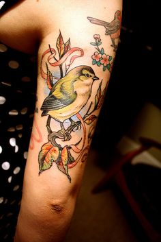 a woman with a bird tattoo on her arm