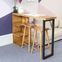 two stools sit at the end of a small table in front of a couch