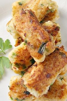 some food is on a white plate and garnished with parsley leafy