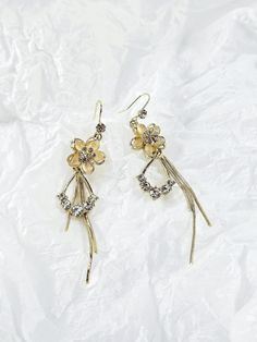 ✧ Perfect as a gift for loved ones or a stunning addition to your jewelry collection, the Elegant Long Floral Tassel Earrings are a versatile accessory that brings beauty and grace to any occasion. Embrace the blend of delicate florals and flowing tassels, and let these earrings become your go-to choice for a touch of refined charm. ✧ This listing is for a pair of earrings. ✧ Material: 925 Sterling Silver covered with Gold plating. ✧ Size: 7 cm. ✧ All jewelry comes in individual and careful pack Elegant Gold Earrings For Mother's Day, Dainty Dangle Flower Earrings For Party, Pierced Metal Drop Flower Earrings, Dangle Flower Earrings With Ear Wire For Mother's Day, Flower Charm Earrings For Mother's Day Anniversary, Elegant Metal Tassel Earrings As Gift, Flower Charm Earrings For Anniversary On Mother's Day, Flower Charm Earrings For Anniversary And Mother's Day, Gold Flower-shaped Earrings For Mother's Day