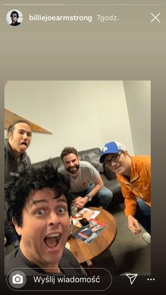 a group of men sitting around a coffee table in a living room with their mouths open